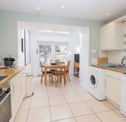 A kitchen with a table and chairs and appliances at Rothay Cottage in Ambleside