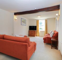 A living room with sofas and a television at Iona Cottage Southwold