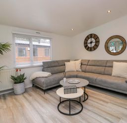 A living room with a grey sofa and coffee table at Cosy Corner, White Cross Bay near Troutbeck Bridge