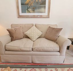 Beige sofa with three cushions and two side tables with lamps in a living room at Flat 1 in Scarborough