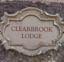 A stone plaque with the words Clearbrook Lodge mounted on a stone wall at Clearbrook Lodge in Llanarthney nr Llandeilo Carmarthenshire