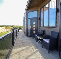 An outdoor area with seating and a door at The Lodge @ Racecourse House Babell near Holywell