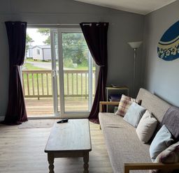 A living room with a sofa and coffee table at Chalet 3 Wipeout in Hayle