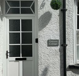 A door with a sign reading Unicorn Cottage at Unicorn Cottage in Ambleside