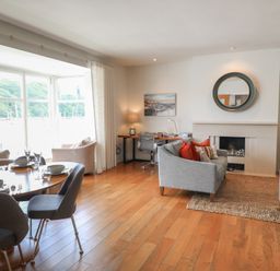 A living room with a table and chairs at 22 Dart Marina in Dartmouth
