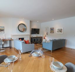 A living room with a sofa, television and desk at 22 Dart Marina Dartmouth