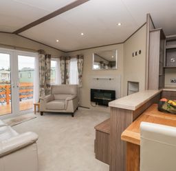 A living room with a sofa and armchair at Aspen in Denny