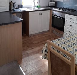 A kitchen with a sink and oven at Oak in Denny
