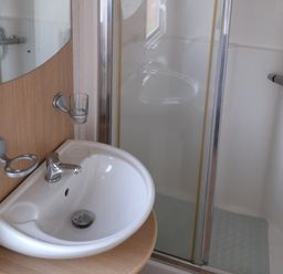 A bathroom with a sink and shower at Oak in Denny