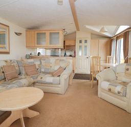A living room with sofa and dining table at Birch in Denny
