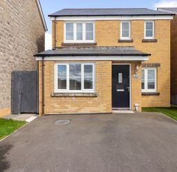 A front view of a two-story brick house with a black door and white windows at 69 Ffordd Y Meillion in Llanelli