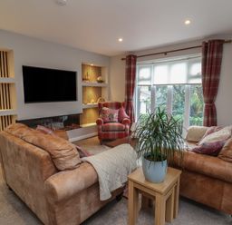 A living room with a sofa and armchair at Little Willesleigh Goodleigh near Barnstaple