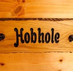 A wooden nameplate with the word Hobhole mounted on a wooden wall at Hobhole in Keal Cotes near East Kirkby