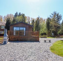 An outdoor view of a house with a deck and gravel area at Lakeside Lodge Bowland Lakes Leisure Village near Garstang