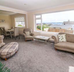 A living room with a sofa and a coffee table at Karenza in Penzance