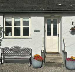 A bench in front of the entrance door at Fox Howe in Thornthwaite