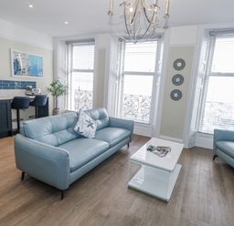 A living room with a sofa and coffee table at Vista Mare 1 in Weymouth