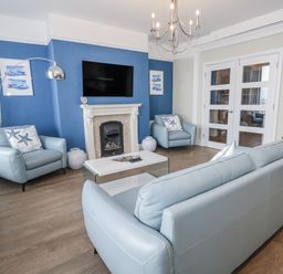 A living room with a sofa and armchairs at Vista Mare 1 in Weymouth