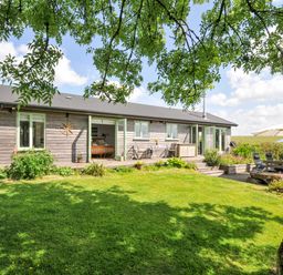 A house with windows and garden furniture at Smugglers Bodmin Moor, St Breward near St Tudy