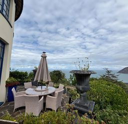 An outdoor dining area with a table and chairs at Bayview Tower in Lynton
