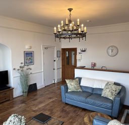 A living room with a sofa and television at Bayview Tower in Lynton