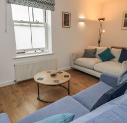 A living room with a coffee table and sofa at Weyside in Weymouth