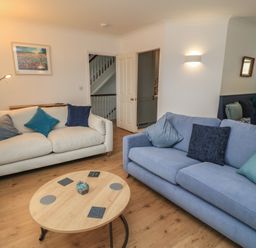 A living room with sofas and a coffee table at Weyside in Weymouth