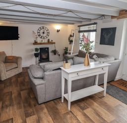 A living room with a sofa and armchair at 41 St. James Street Narberth