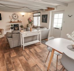 A living room with a sofa and dining table at 41 St. James Street Narberth