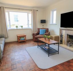 A living room with a sofa and coffee table at Bayview Cottage in Southbourne