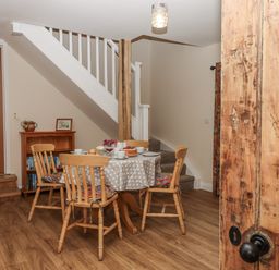 A dining room with a table and chairs at Aunty Junes Cottage Okehampton