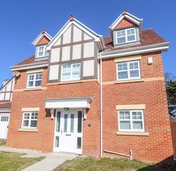 A brick house with white windows and a white front door at 9 Beckett Close in Colwyn Bay