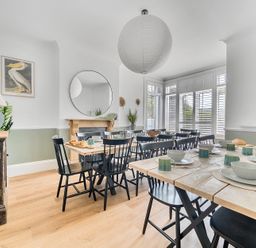 A dining room with a table set for meals at Palm House in Newquay