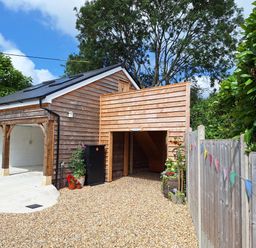 A garage with a driveway and gravel at The Halt in Maiden Newton