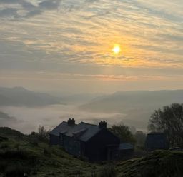A house surrounded by hills and trees at Ty Llewelyn in Capel Curig near Betws-Y-Coed