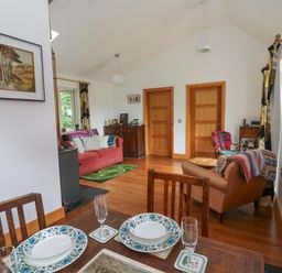 A living room with a table and chairs at Delfryn in Llandeilo