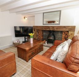 A living room with a coffee table and television at The Museum in Nenthead
