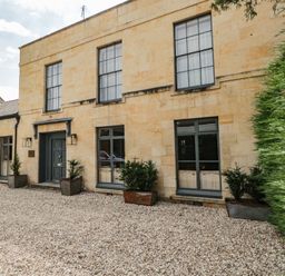 A building with windows and a door in an outdoor area at Cotswold House Moreton-In-Marsh