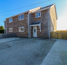 A house with a driveway and fence at 15 Llys Tegeirian Llangristiolus near Llangefni