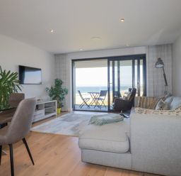 A living room with a sofa and a tv at Apartment 8 in 