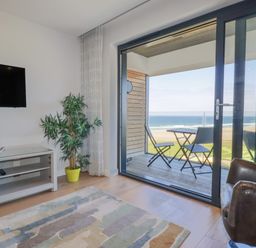 A living room with a television and couch at Apartment 8 