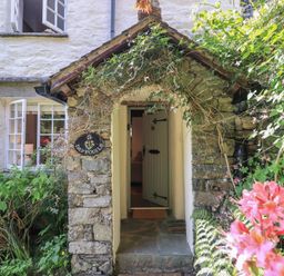 An entryway with a stone structure and a door at Daffodils Ambleside