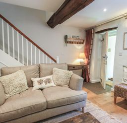 A living room with a sofa and coffee table at Daffodils in Ambleside