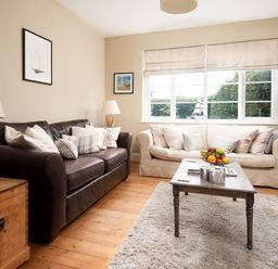 A living room with a sofa and coffee table at Driftwood in Embleton