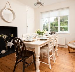A dining room with a table and chairs at Driftwood in Embleton