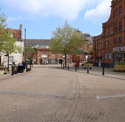 An outdoor area with trees and people at Apartment 1 Brewers Quay in Weymouth