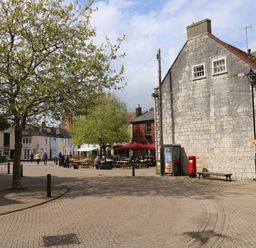 An outdoor area with benches and a tree at Apartment 1 Brewers Quay in Weymouth