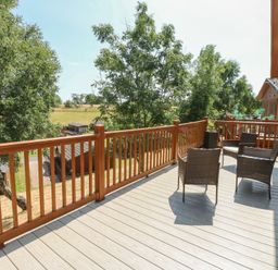 An outdoor area with chairs on the deck at Finnbars Lodge in Richmond