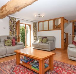 A living room with sofas and a coffee table at Swallows Reach Halwell