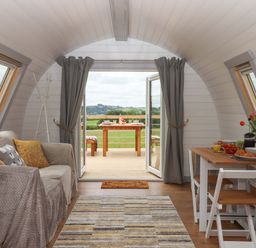 A living room with a sofa and table at Under Oak Pod in Totnes